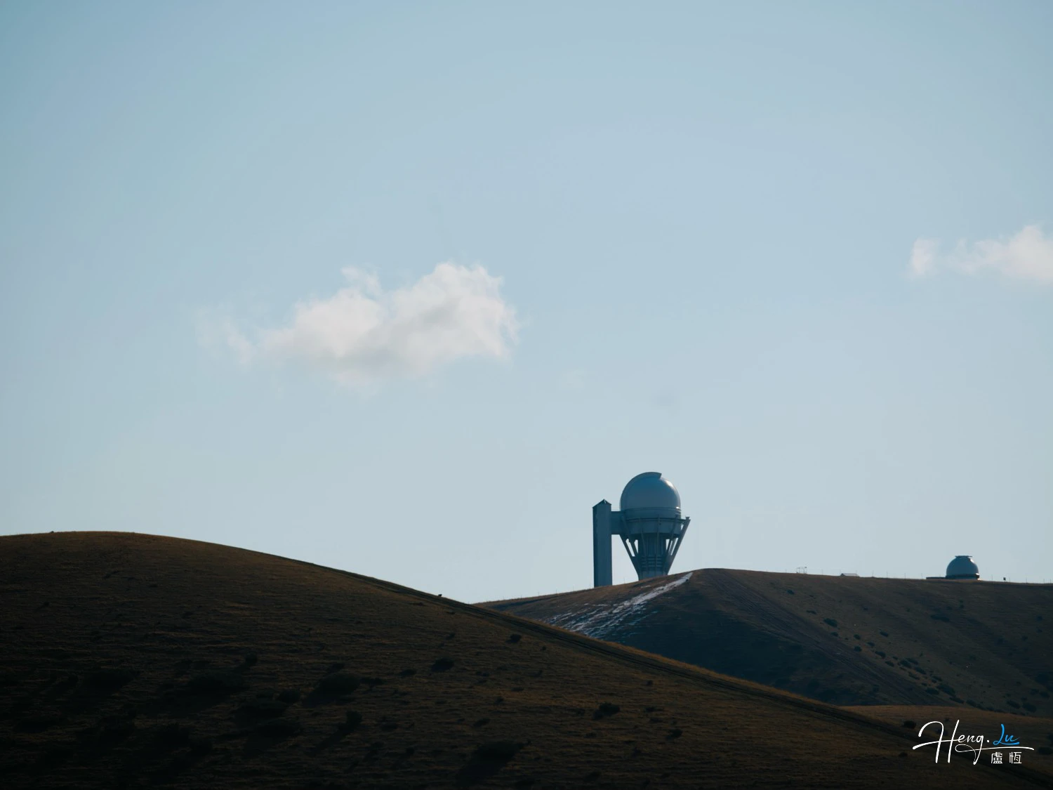 Observatory-dome-on-mountain-under-blue-sk