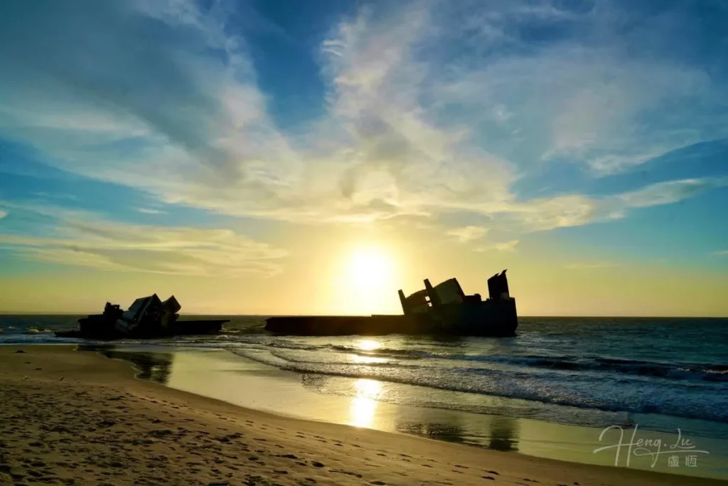 African Beach Sunset with Shipwrecks Rusty-shipwreck-on-beach-during-sunset-in-Africa