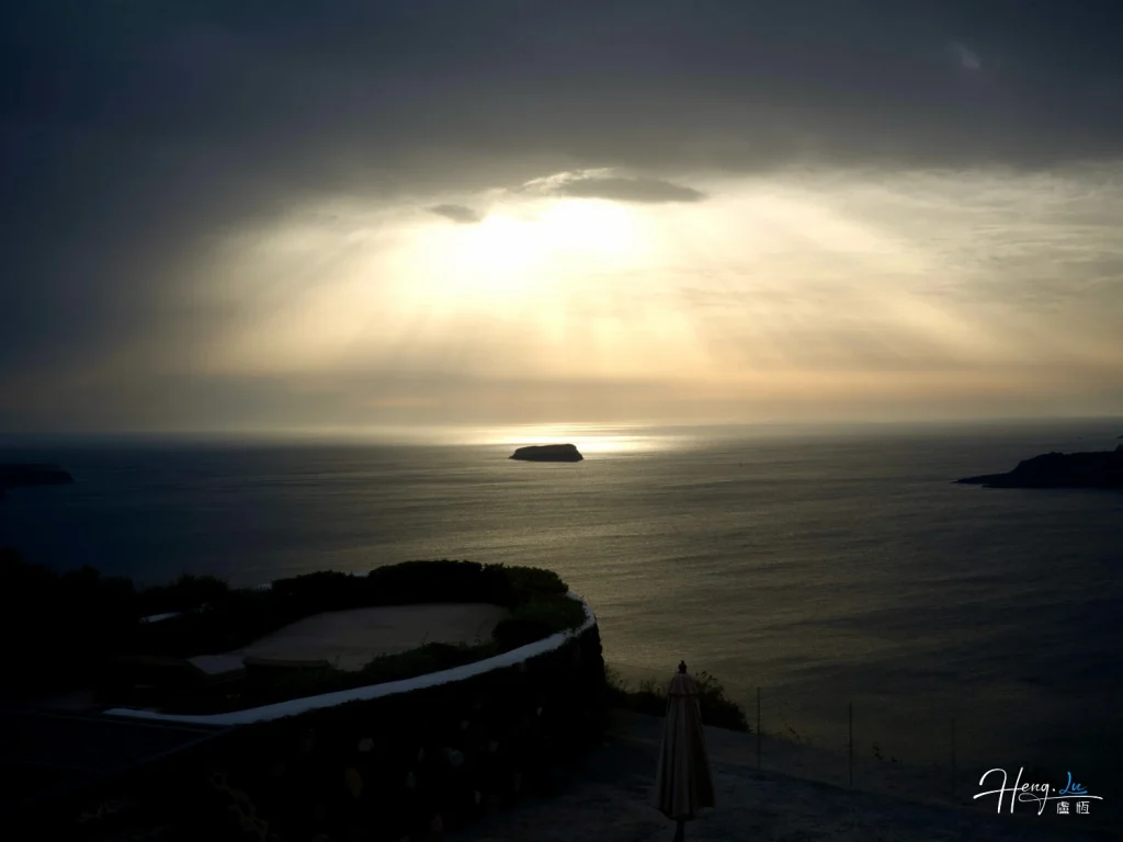 Sunrays Breaking Through Clouds Over Sea with Island and Coastal Scene Sunrays-breaking-through-clouds-over-sea