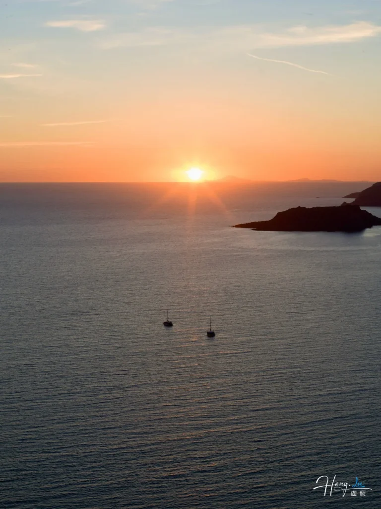 Golden Sunset Over Calm Sea with Boats and Coastal Island Sunset-over-sea-with-two-sailboats