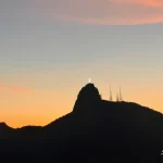 Evening glow over a mountain ridge Sunset-silhouette-with-mountain-and-statue