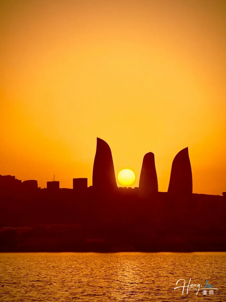 Sunset Over a Modern City: A Silhouette by the Water
