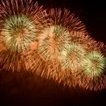 orange-and-green-fireworks-bursting-across-night-sky