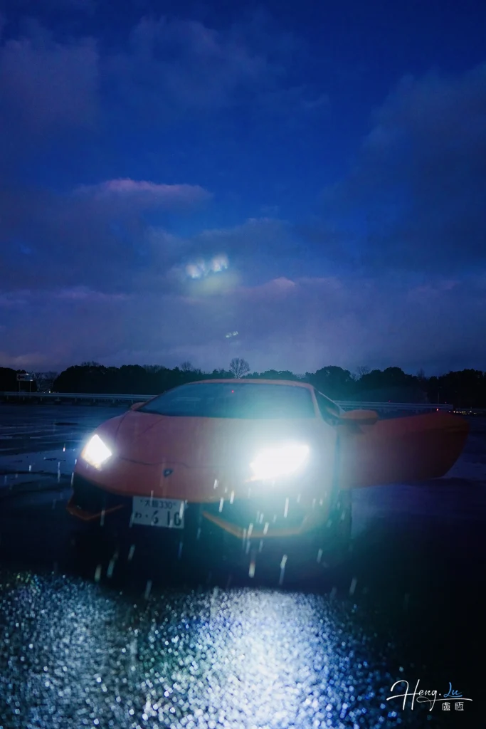 The pause before motion sports-car-with-headlights-on-in-rainy-night