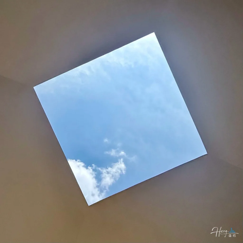 Square Skylight Framing Blue Sky with White Clouds in Minimalist Scene square-skylight-framing-blue-sky-with-white-cloud
