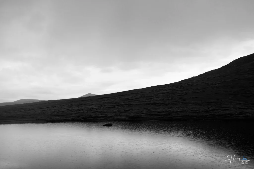 Black and White Seascape with Distant Island and Mountainous Horizon black-and-white-landscape-with-hill-and-lake