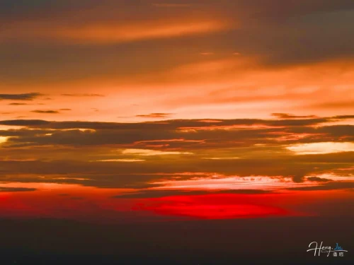 Vibrant-orange-and-red-sunset-over-cloudy-evening-sky