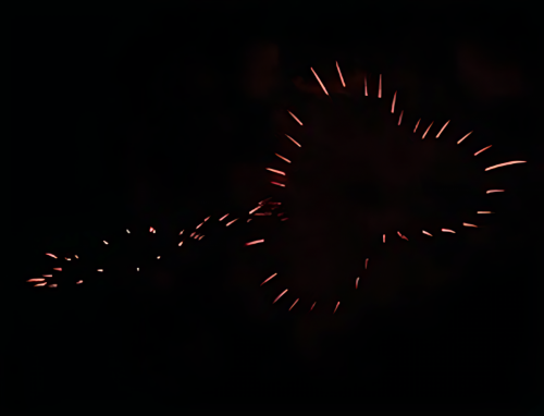 Red-firework-trails-forming-heart-shape-in-dark-sky